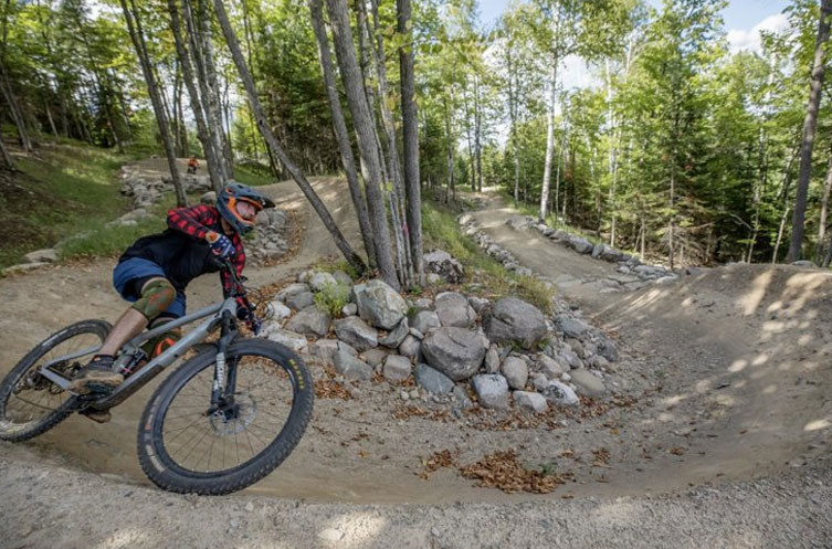 Mountain biker riding through the corner of a downhill trail